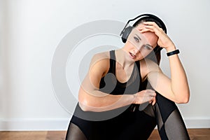 Sporty woman with headphones tired after workout