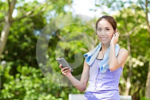 Sporty woman hold with cellphone and listen to music