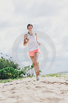 Sporty woman jogging at the beach