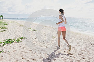 Sporty woman jogging at the beach
