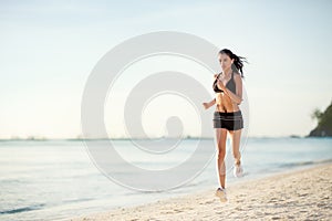 Sporty woman jogging on seaside