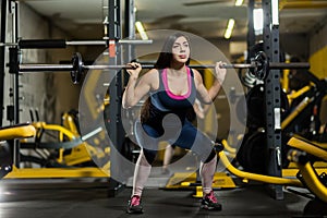 Sporty woman lifting weights. Fit girl exercising building muscles. Fitness and bodybuilding