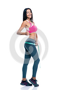 Sporty woman measure her buttocks with a measuring tape