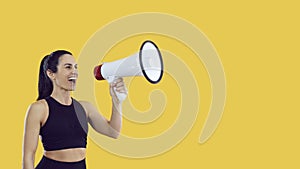 Sporty woman with megaphone making sale announcement on yellow copy space background