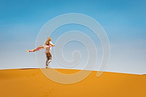 Sporty woman in Merzouga dunes of Sahara desert Morocco