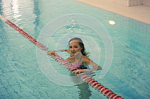 Sporty woman. picture of young girl standing in water in indoor pool