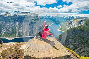 Sporty woman posing on Trolltunga Norway