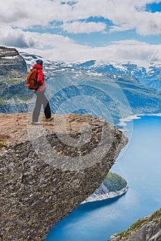 Sporty woman posing on Trolltunga Norway