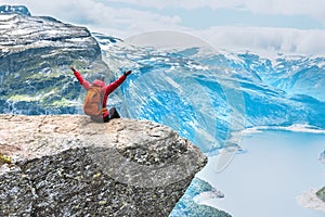 Sporty woman posing on Trolltunga Norway