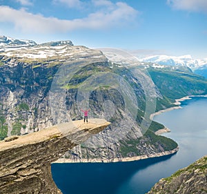 Sporty woman posing on Trolltunga Norway