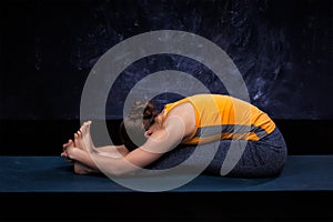 Sporty woman practices Ashtanga Vinyasa yoga asana photo