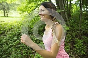 Sporty woman running outdoors in park