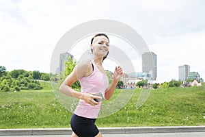 Sporty woman running outdoors in park