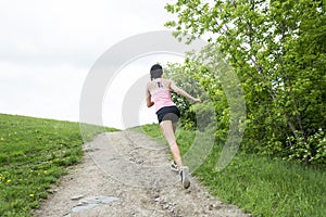 Sporty woman running outdoors in park