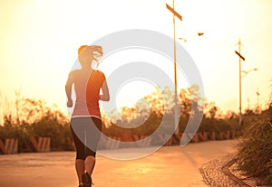 Sporty woman running sunrise