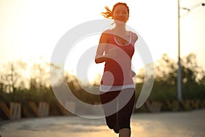 Sporty woman running sunrise
