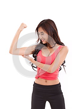 Sporty woman showing, checking her biceps arm muscle