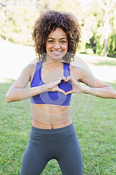 Sporty woman showing heart shape