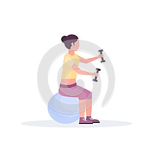 Sporty woman sitting fitness ball girl holding dumbbells doing exercises training in gym aerobic pilates workout healthy