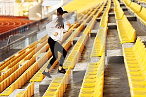 Sporty woman at the stadium on the stairs