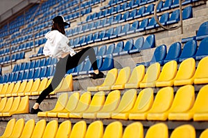 Sporty woman at the stadium on the stairs