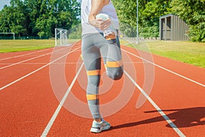 Sporty woman stretching on running track