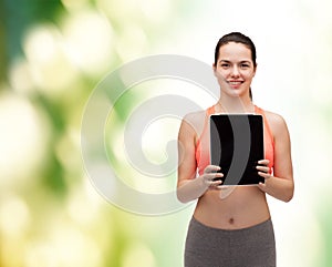 Sporty woman with tablet pc blank screen