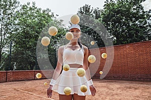 Sporty woman throwing a tennis ball