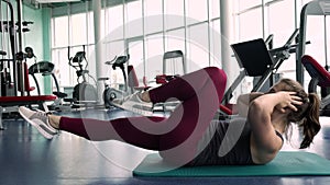 Sporty Woman Training Abdominal and Core Muscles in the Gym.