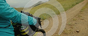 The sporty woman travels on a bicycle with bikepacking bags. The sportswoman traveler journey on bicycle touring in