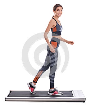 Sporty woman using walking treadmill on white background