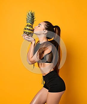 Sporty woman waist with measure tape and pineapple