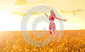 Sporty woman in wheat field