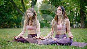 Sporty Women doing Meditaton in Park. Stretch, Yoga workout and Concentration