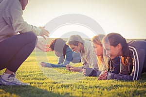 Sporty women planking during fitness class photo