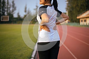 Sporty women suffering from pain in waist  injury after sport exercise running jogging and workout outdoor