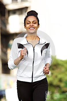 Sporty young african woman running outdoors