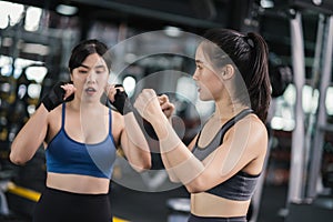 Sporty young asian women training boxer wearing strap on wrist with coach, Boxing practice sports