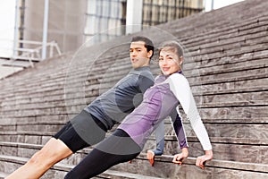 Sporty young couple holding reverse plank position