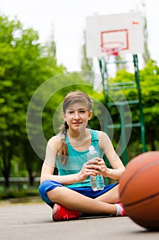 Sporty young girl on a basketball court