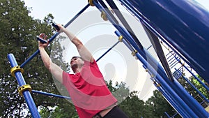 Sporty Young Man Doing Pull Ups Exercise.