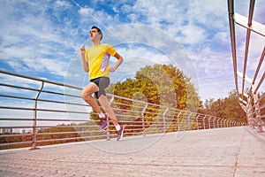 Sporty young man running during cardio workout