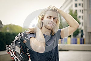 Sporty young man with skates