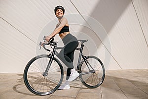 Sporty young woman with bicycle do sports activity. Healthy lifestyle concept