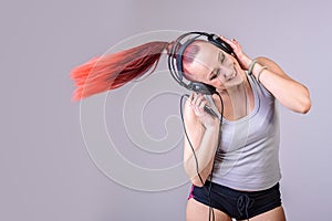 Sporty young woman dancing to music