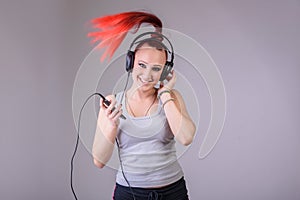 Sporty young woman dancing to music