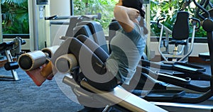 Sporty young woman doing abs exercises in gym. Top view of fit woman doing abs crunches.