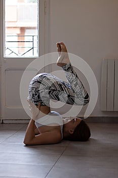 Sporty young woman doing yoga at home - concept of healthy life and natural balance between body and mental development