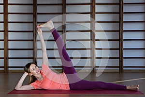 Sporty young woman doing yoga practice - concept of healthy life and natural balance between body and mental development