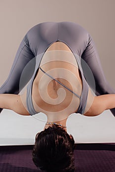 Sporty young woman doing yoga practice on white background. Concept of healthy life and balance between body and mental